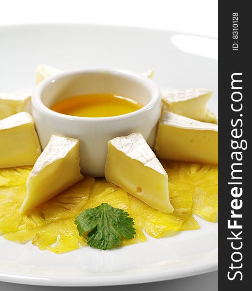 Fromage (Soft Cheese) with Honey Sauce and Fresh Pineapple. Isolated on White Background. Fromage (Soft Cheese) with Honey Sauce and Fresh Pineapple. Isolated on White Background