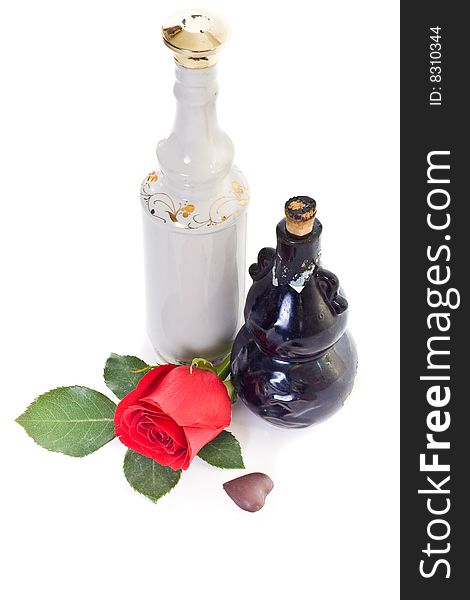 Still life with two bottles, red rose and chocolate heart. Still life with two bottles, red rose and chocolate heart