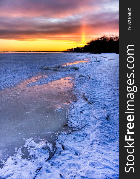 Sunset over a frozen lake.