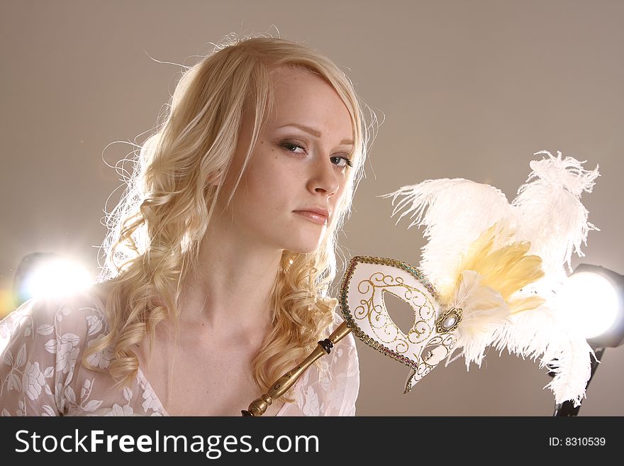 Beautiful young woman with Venetian mask, studio photo. Beautiful young woman with Venetian mask, studio photo