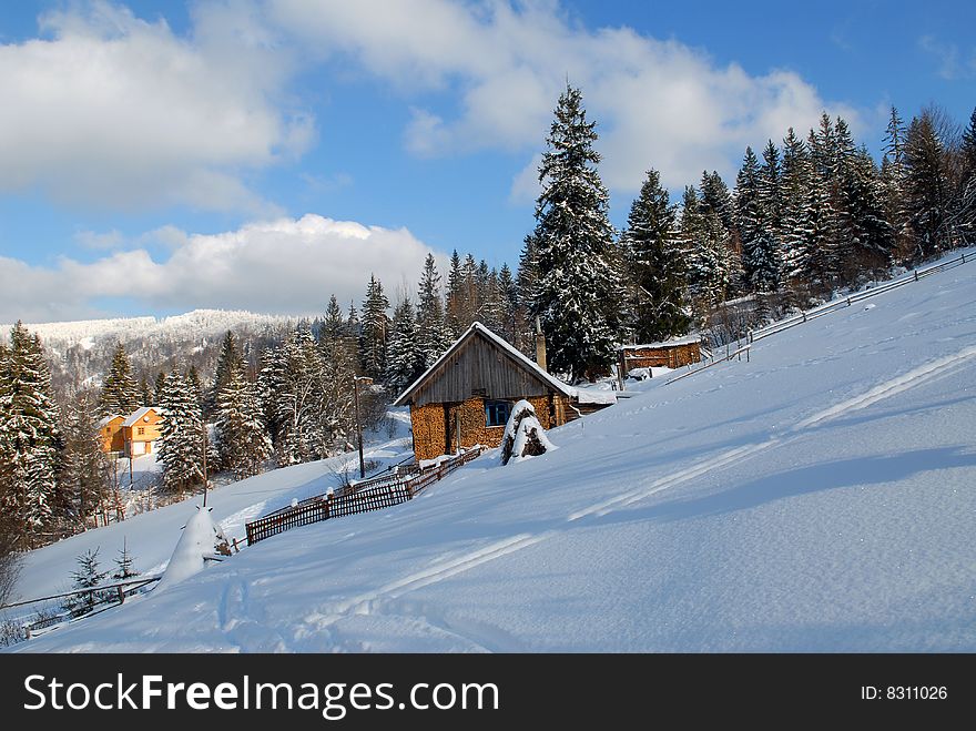 House in Carpathians in the winter and a haystack