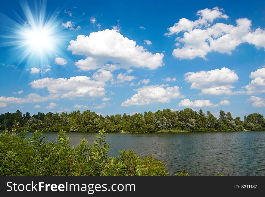 Summer landscape with lake and sun