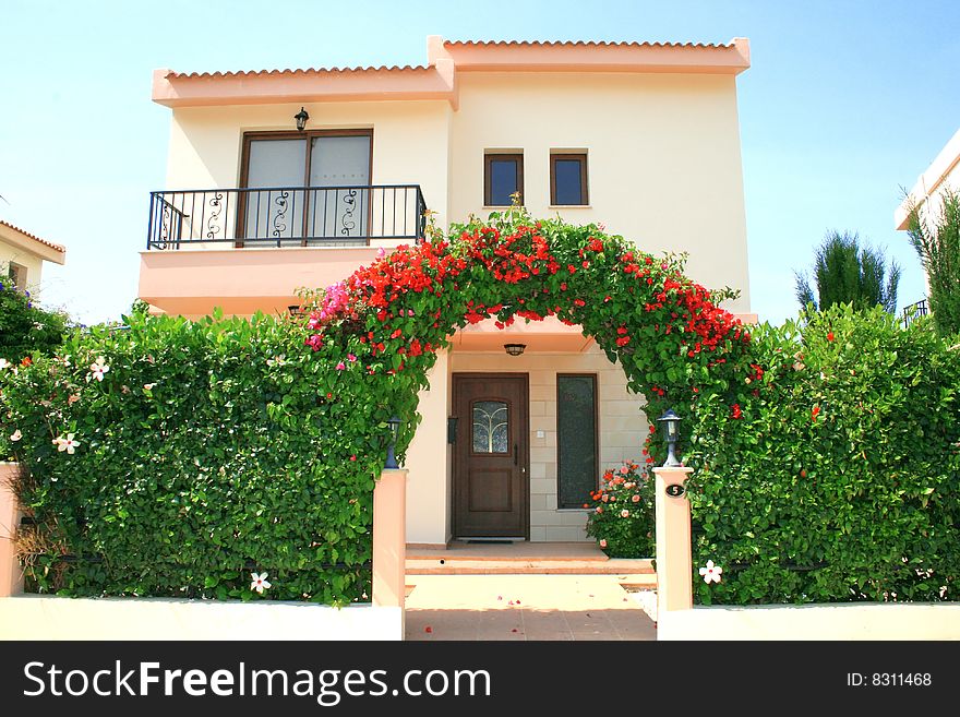 Beautiful house with flowers arch. Beautiful house with flowers arch.