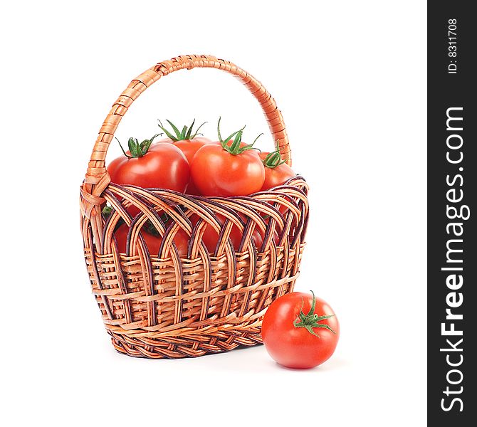 Red ripe tomatoes in a basket isolated over white. Red ripe tomatoes in a basket isolated over white