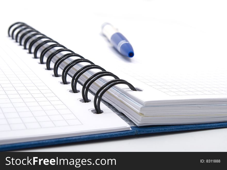 Blank notebook with blue pen on white background, closeup view