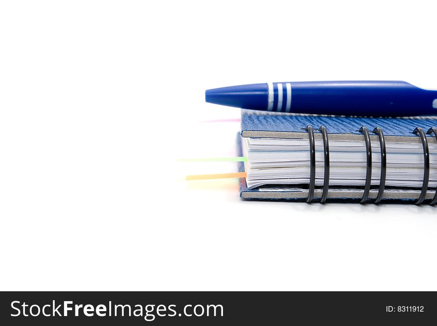 Blue notebook and blue pen isolated on white background