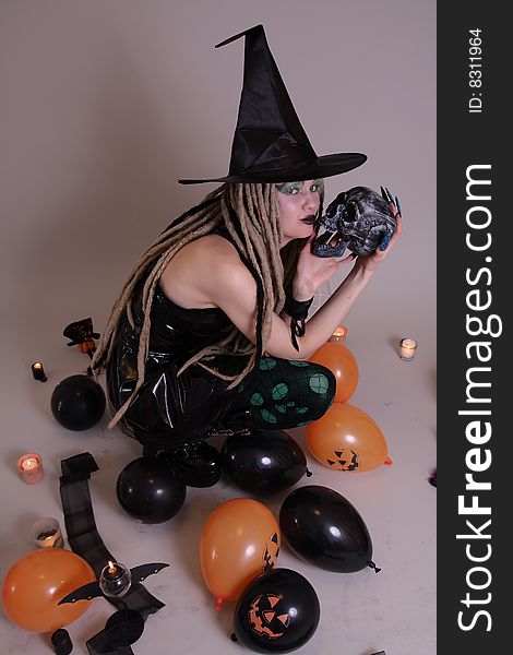 Young woman with pumpkin and Halloween setting