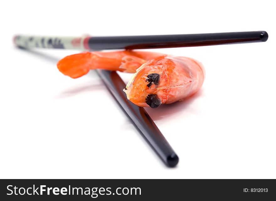 Big shrimp and sushi chopsticks isolated on white background