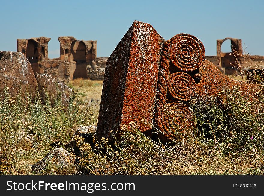 Antic fallen column in ruins of ancient Ani, Turkey. Detail of decorated head of column.