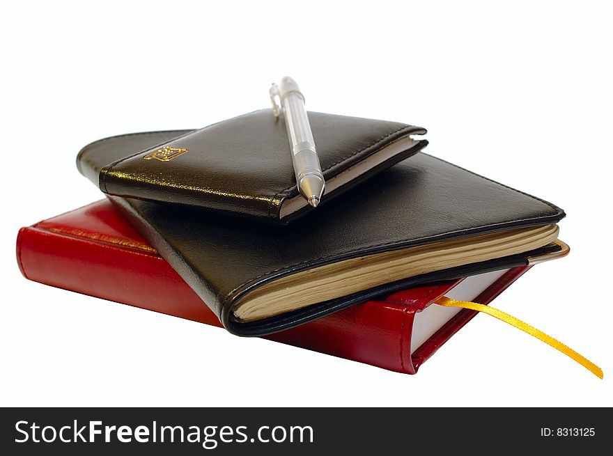 Three notebooks (organizers) and jell pen on isolated background. Three notebooks (organizers) and jell pen on isolated background.