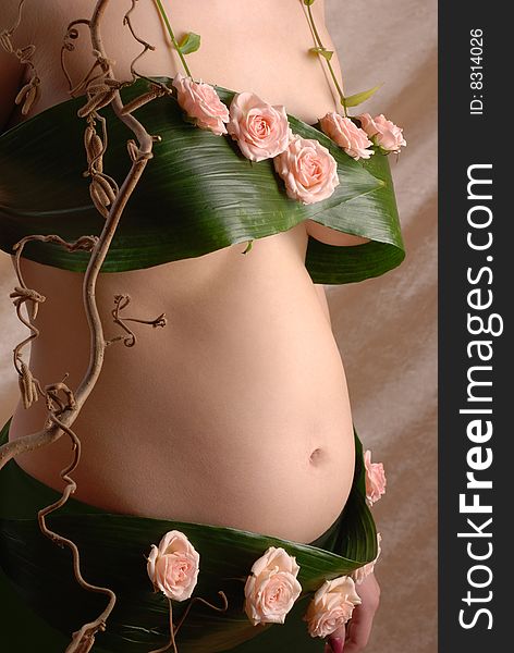Pregnancy woman in the dressing made of a flowers. Pregnancy woman in the dressing made of a flowers