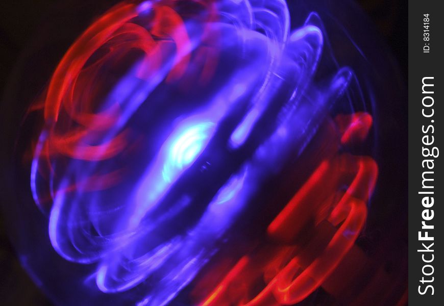 Abstract light pattern made by revolving lights on childs toy.