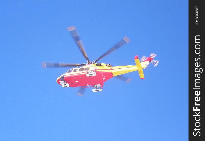 An helicopter rescue flying in a blue sky