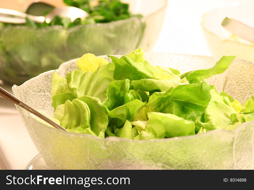 Close up of green salad in glass bowl. Close up of green salad in glass bowl