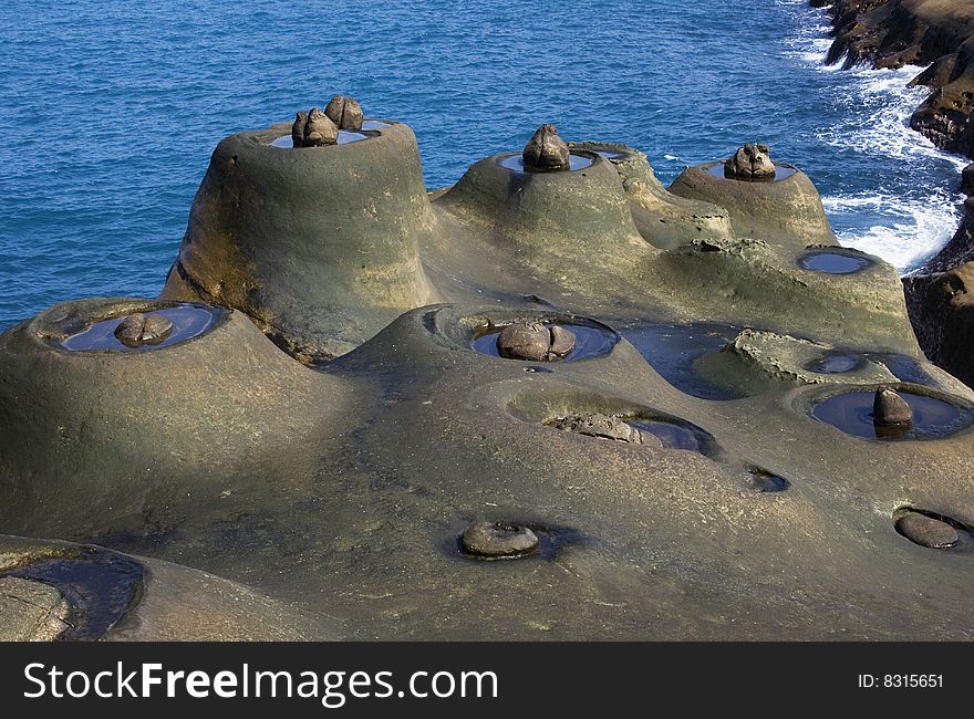 These are strange rocks form from coastal erosion. They look like nests with a single egg on them. Probably wind and water erosion. This is on Taiwan's coastline. These are strange rocks form from coastal erosion. They look like nests with a single egg on them. Probably wind and water erosion. This is on Taiwan's coastline.