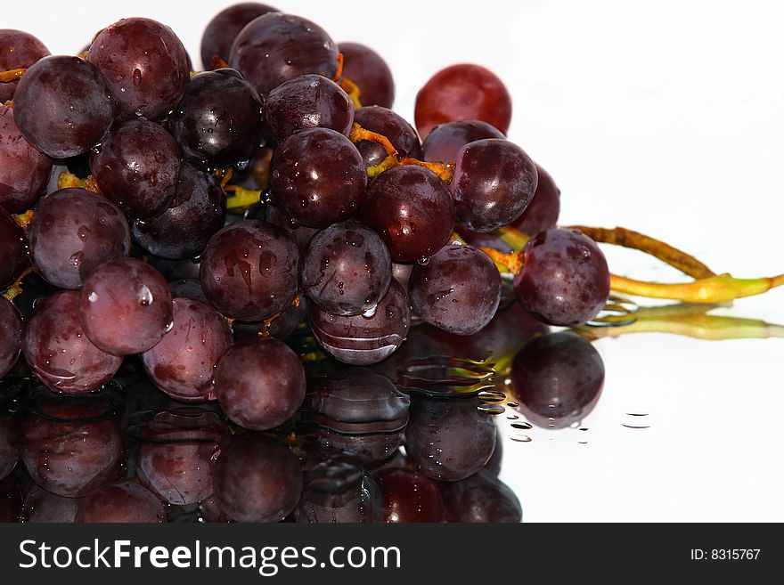 Cluster of pink grape isolated on white background