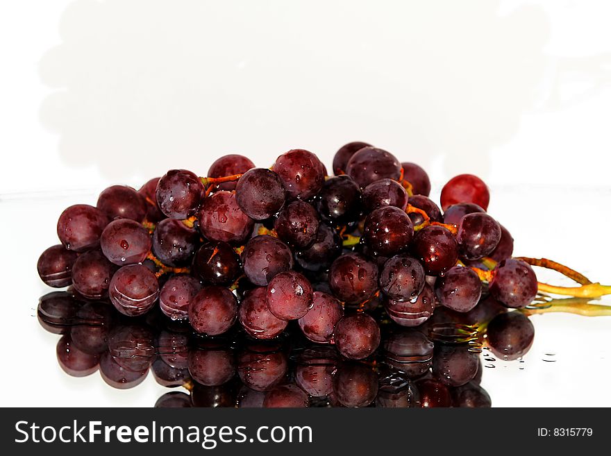 Cluster of pink grape isolated on white background