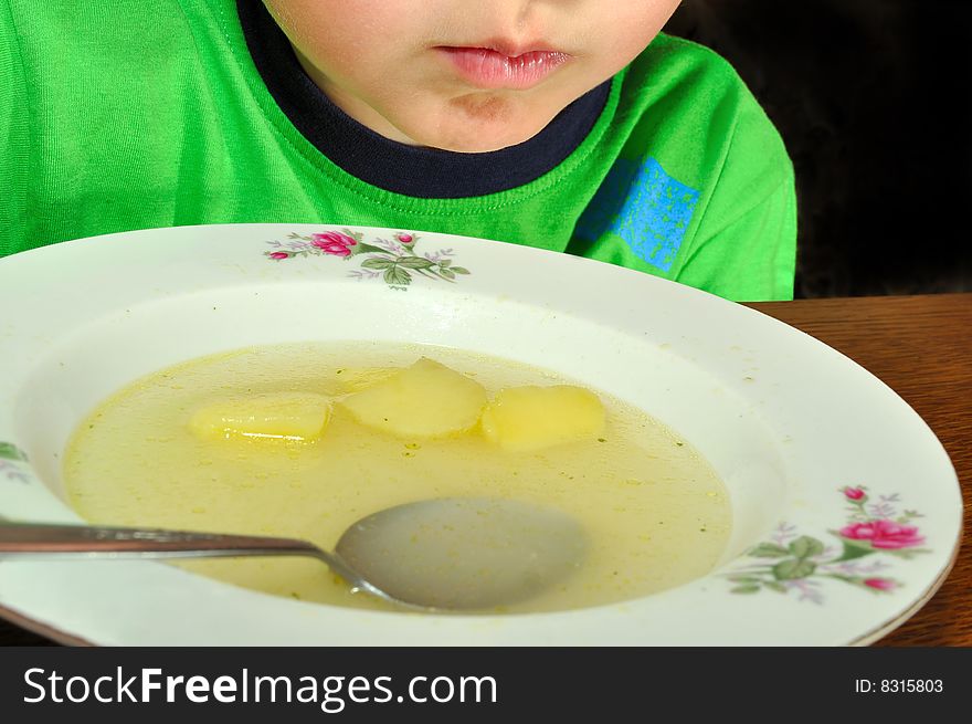 A close-up of a child during a meal. A close-up of a child during a meal