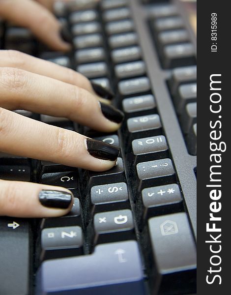 Computer keyboard and woman`s hands typing on it. Computer keyboard and woman`s hands typing on it.