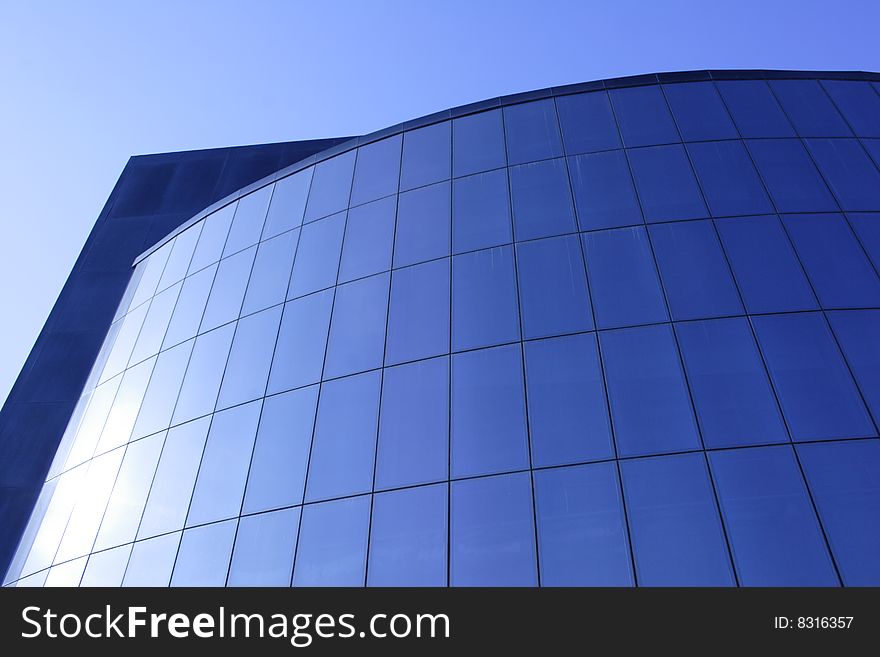 Modern glass office building of dark blue colour. Modern glass office building of dark blue colour