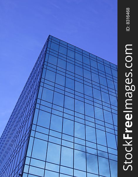 Modern glass office building of dark blue colour. Modern glass office building of dark blue colour