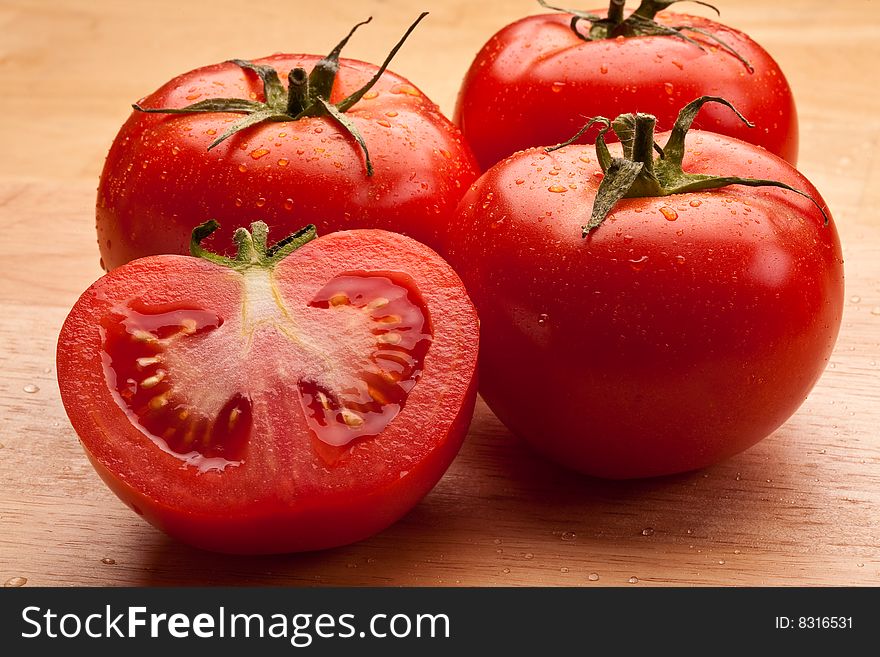 Fresh red tomatoes on the wooden surface