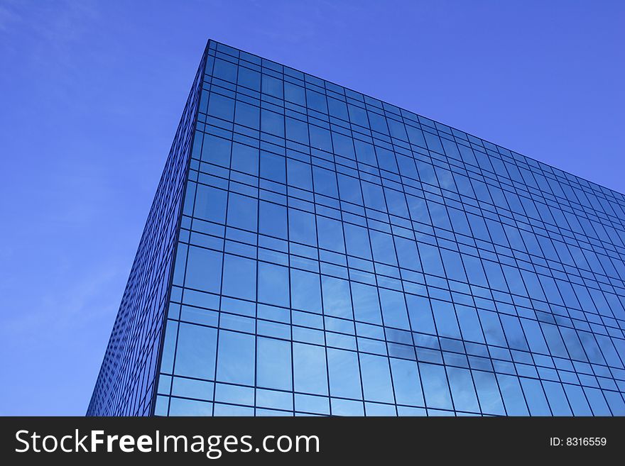 Modern glass office building of dark blue colour. Modern glass office building of dark blue colour