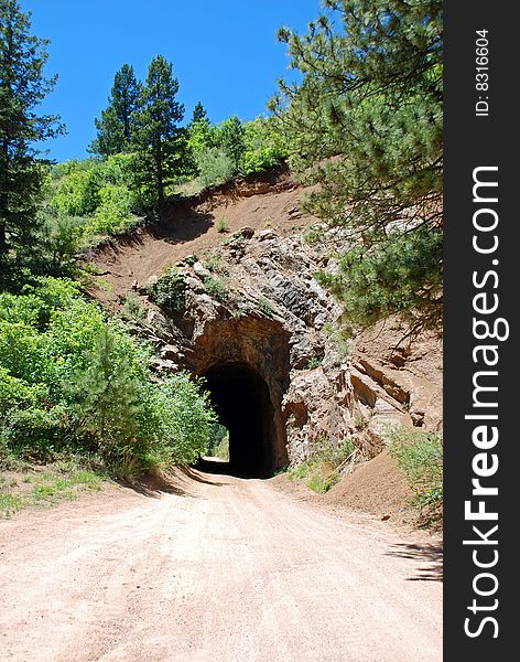 Bore right through mighty sandstone, using primitive 19th century tools, this mountain tunnel stands as a monument to the human will and spirit as well as back-breaking effort.  Crisp air at high altitudes did not stop the pines from adorning this passage as the red clay road bed allowed us to pass through. Bore right through mighty sandstone, using primitive 19th century tools, this mountain tunnel stands as a monument to the human will and spirit as well as back-breaking effort.  Crisp air at high altitudes did not stop the pines from adorning this passage as the red clay road bed allowed us to pass through.