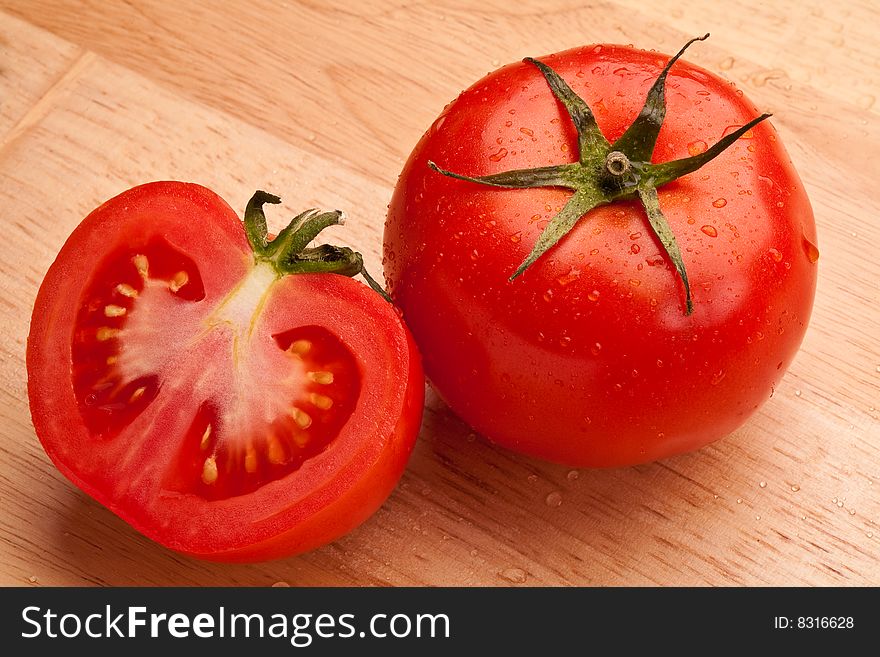 Fresh red tomatoes on the wooden surface