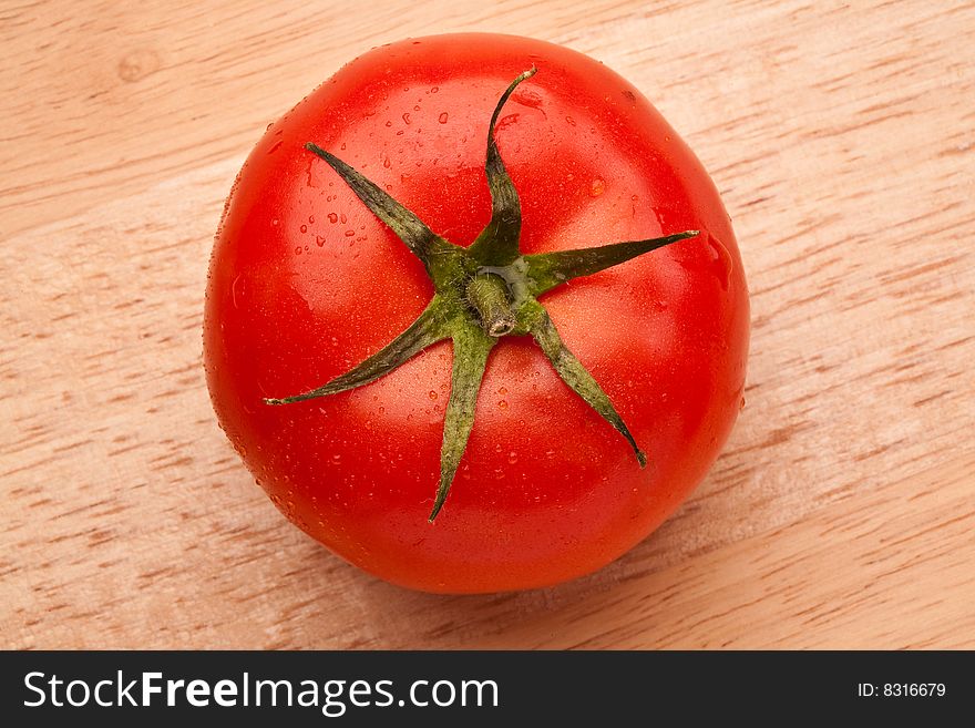 Fresh red Tomato on the wooden surface