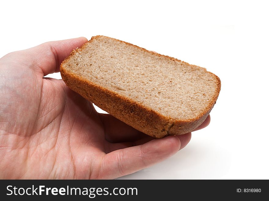 Piece of the pumpernickel in hand insulated on white background