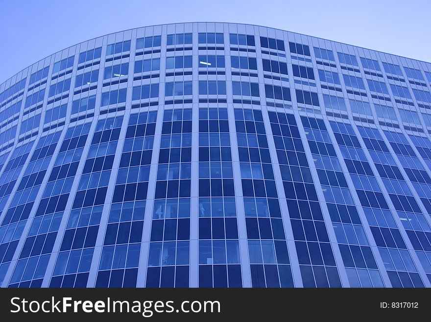 Modern glass office building of dark blue colour. Modern glass office building of dark blue colour
