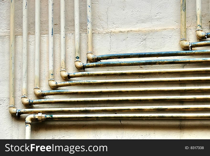 Old gas pipes over a wall. Old gas pipes over a wall