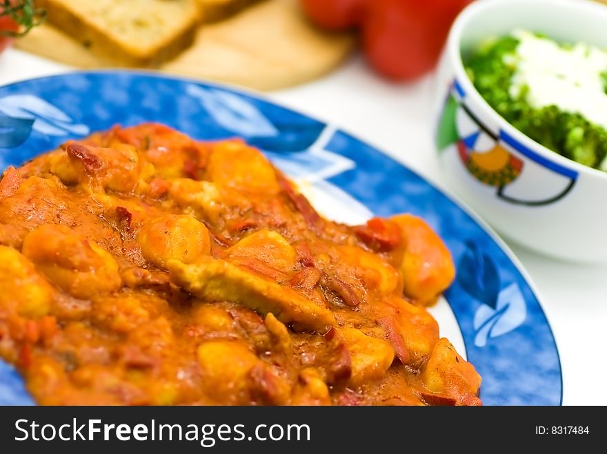 Slice of meat with dumplings-Gnocchi- and red bell pepper  sauce.