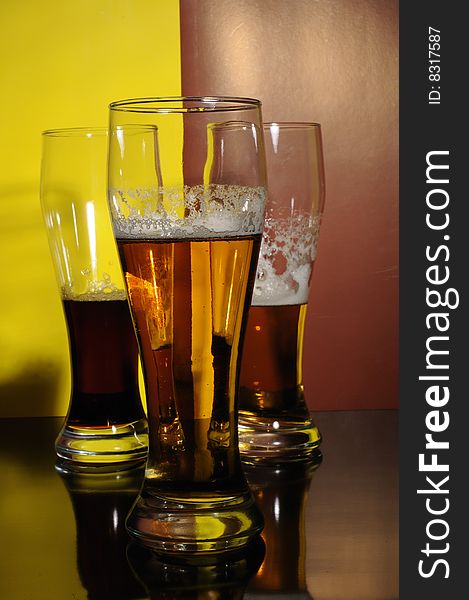 Three glasses with light and dark beer. Three glasses with light and dark beer