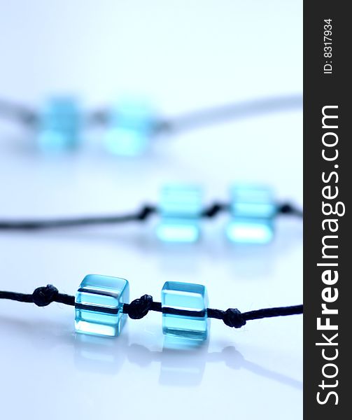 Pair of blue cube beads on navy blue strings. Pair of blue cube beads on navy blue strings