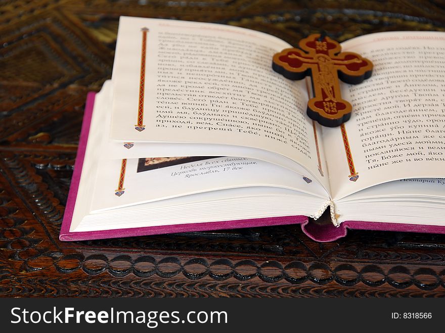 Russian New Testament opened book with wooden cross. Russian New Testament opened book with wooden cross