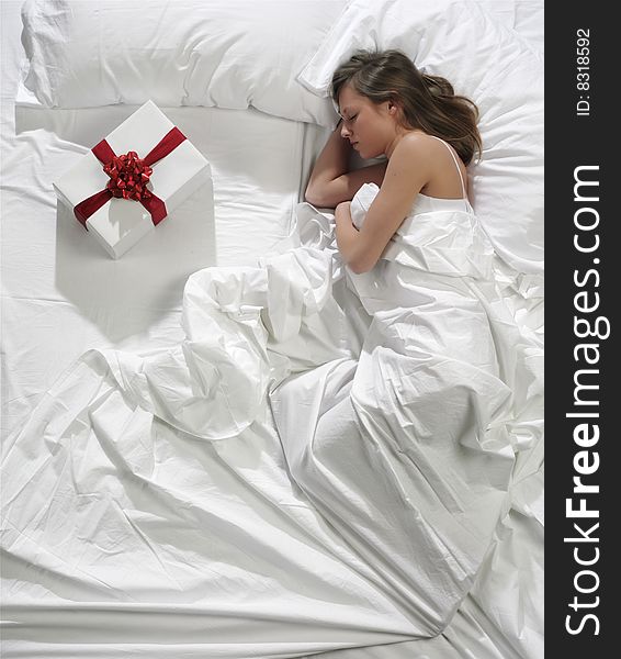 Woman in bed with his present