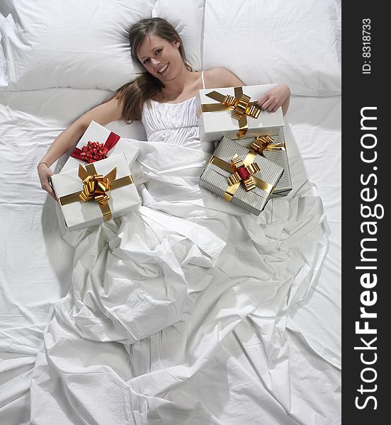 Woman in bed with his present
