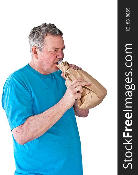 Distraught mature man drinking booze from a paper bag, isolated on white background. Distraught mature man drinking booze from a paper bag, isolated on white background.