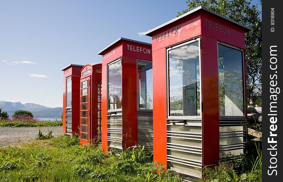 Four old telephone boxes on  non-urban  background
