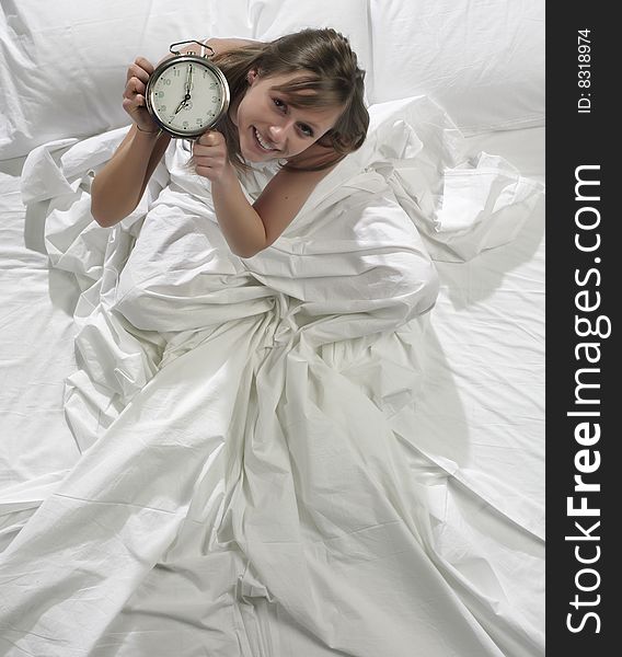 Woman in bed with alarm clock. Woman in bed with alarm clock