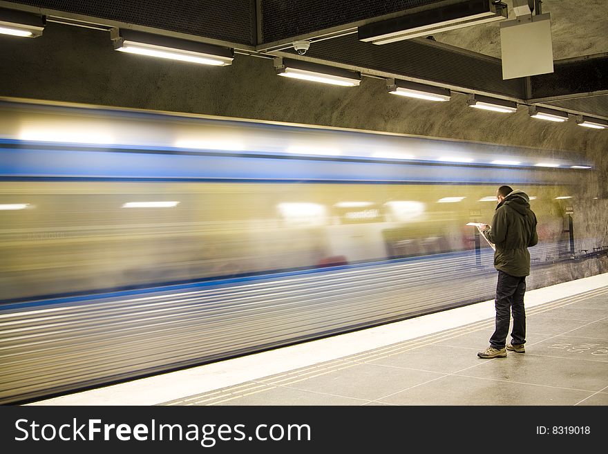 Fast train passing by. motion blur. man reading newspaper. Fast train passing by. motion blur. man reading newspaper