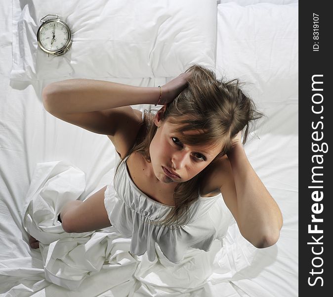 Woman in bed with alarm clock. Woman in bed with alarm clock