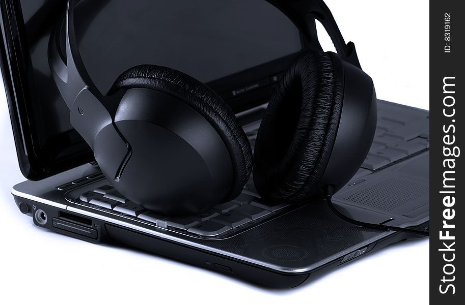 Laptop and headphones on white background