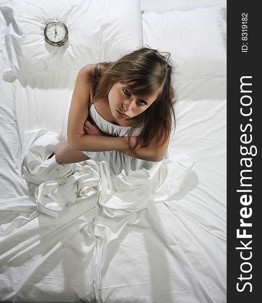 Woman in bed with alarm clock. Woman in bed with alarm clock