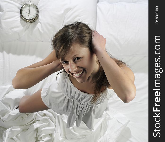 Woman in bed with alarm clock. Woman in bed with alarm clock