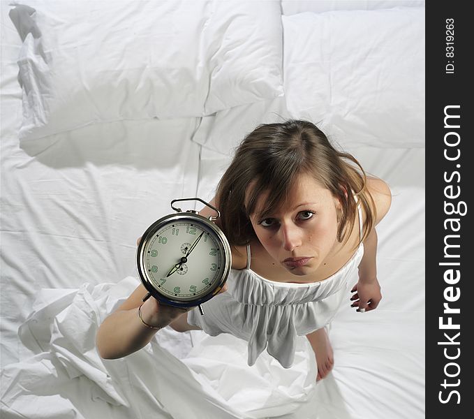 Woman in bed with alarm clock. Woman in bed with alarm clock