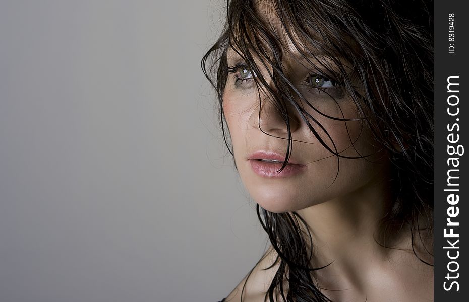 Close-up portrait of beautiful wet brunette