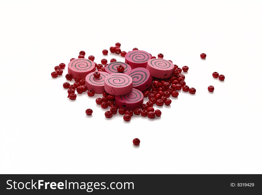 Round pink wooden beads. Isolated